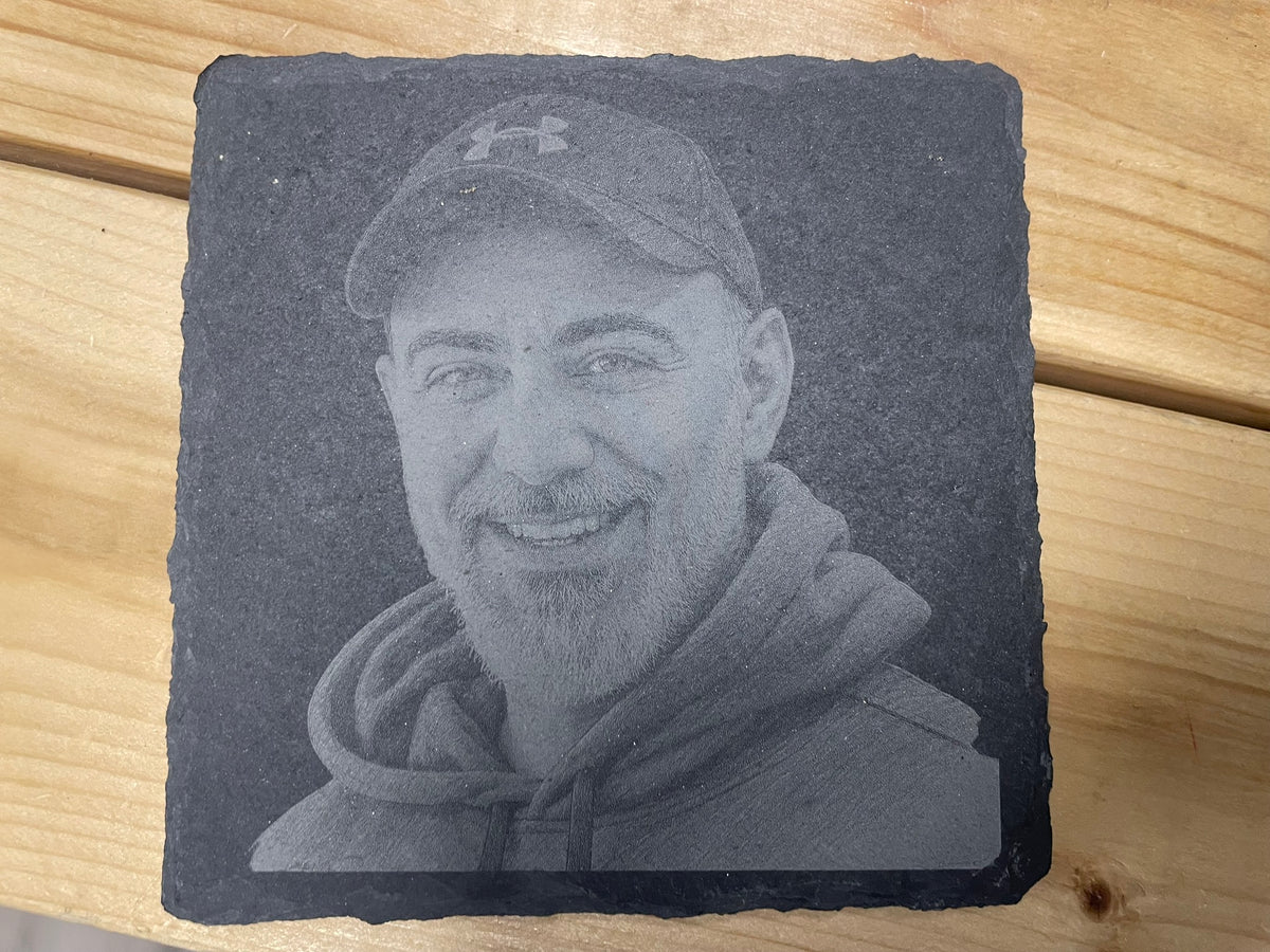 Custom portrait photo engraved on natural slate beside the original photograph