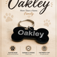Personalized black acrylic pet ID tag engraved with a dog’s name